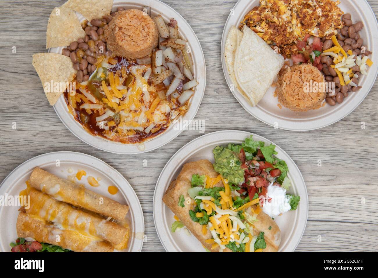 Festa del cibo messicano con un chimichanga, taquitos di pollo, chorizo e uova, e gli allevatori di huevos per una scelta tra colazione e pranzo. Foto Stock