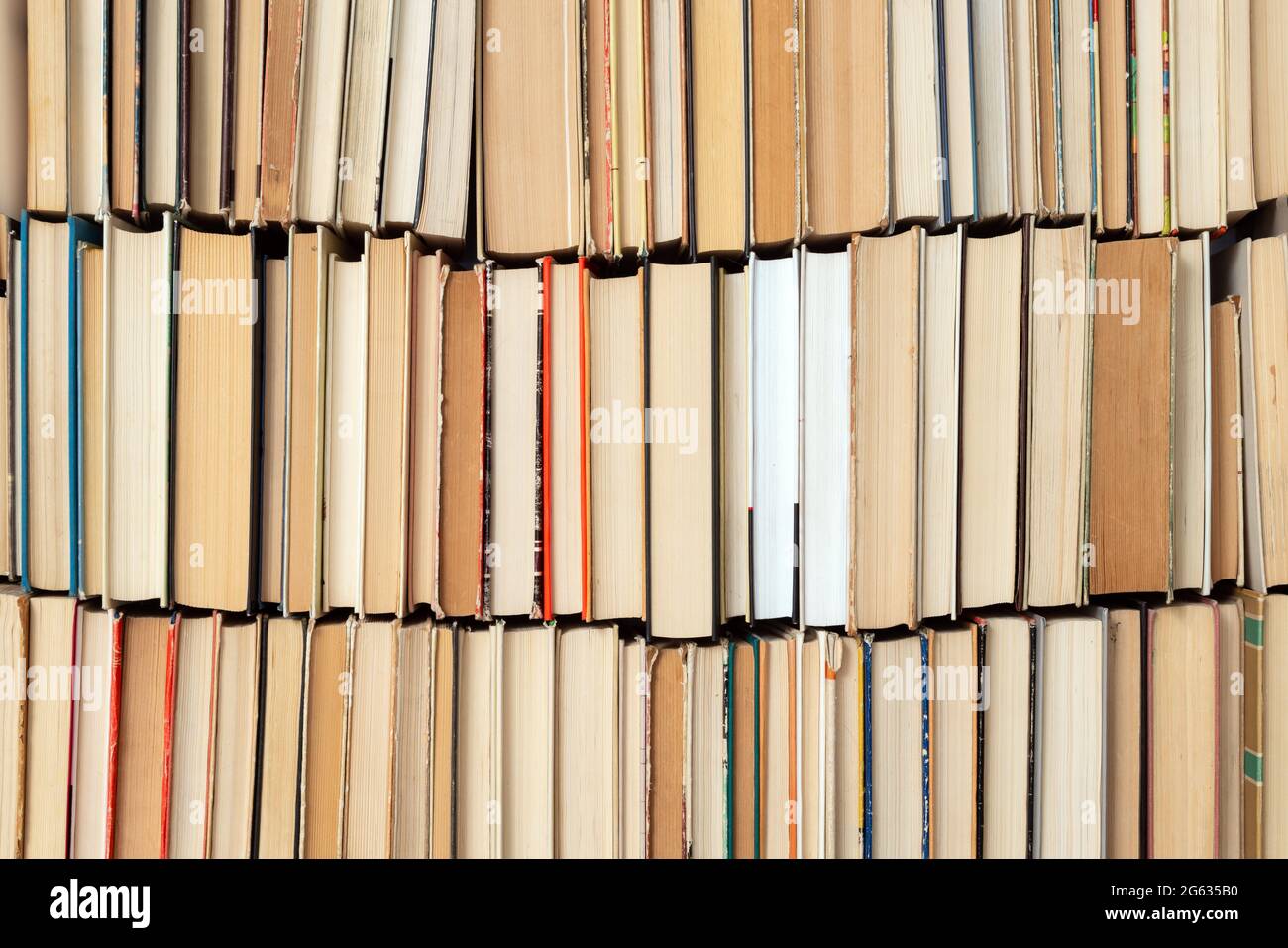 Sfondo del libro d'epoca. Libri vecchi e usati di hardback impilati uno accanto all'altro. Concetto di istruzione e di studio. Nessuno Foto Stock