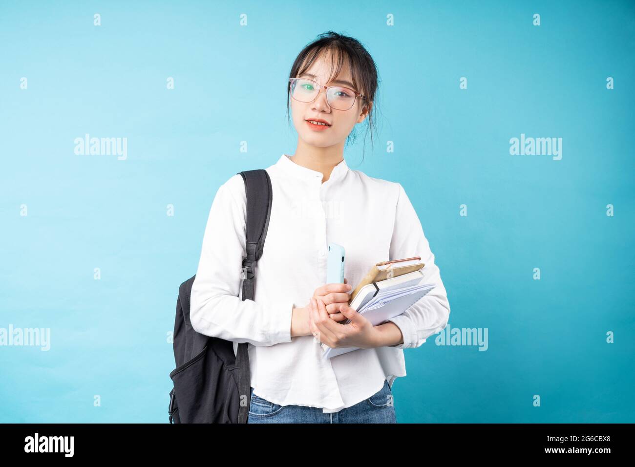 Ritratto di una bella studentessa su sfondo blu Foto Stock