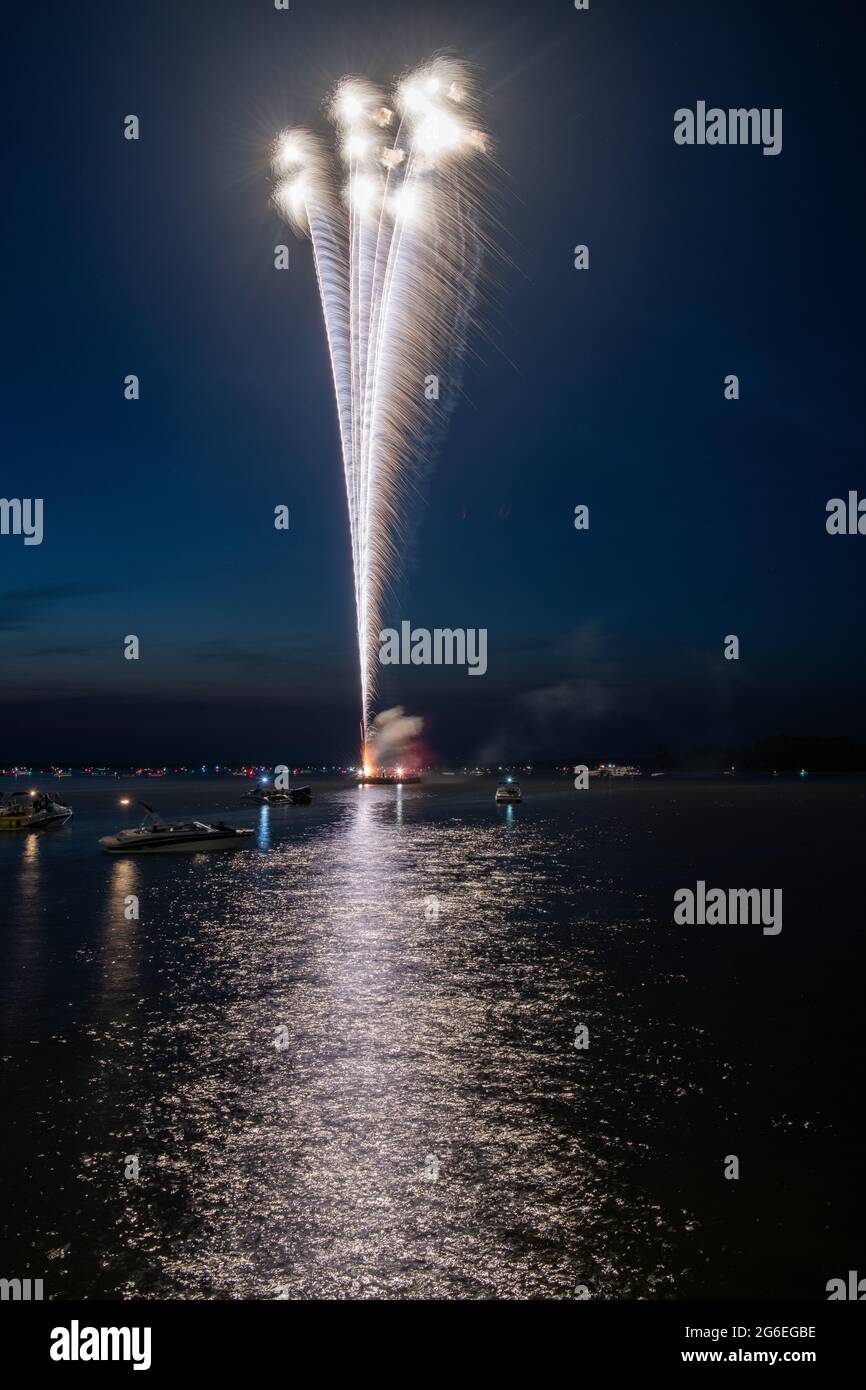 Fuochi d'artificio il 4 luglio sparato da una chiatta su un lago. Foto Stock