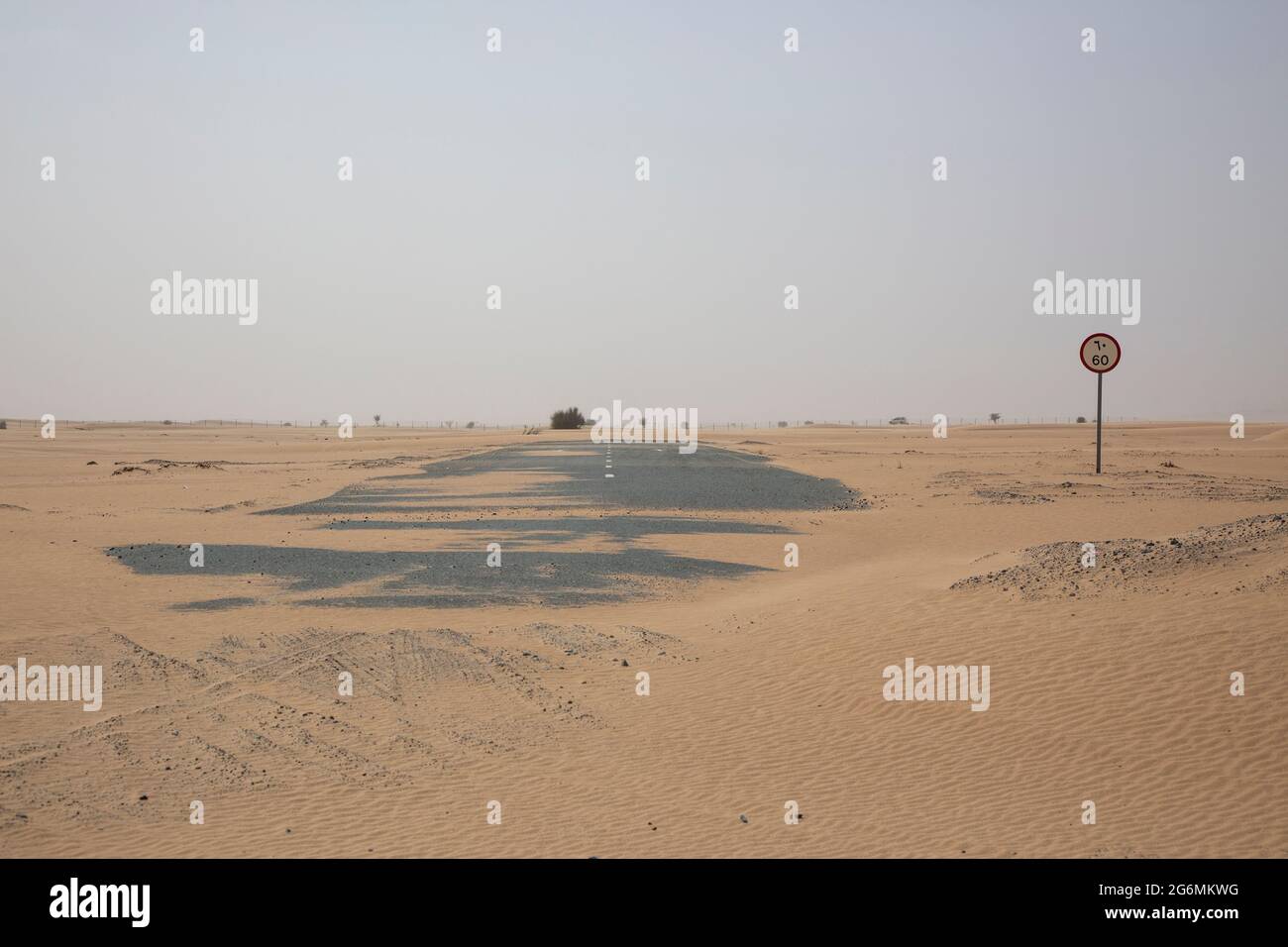 Una strada coperta di sabbia dopo una tempesta di sabbia a Dubai, Emirati Arabi Uniti. Foto Stock