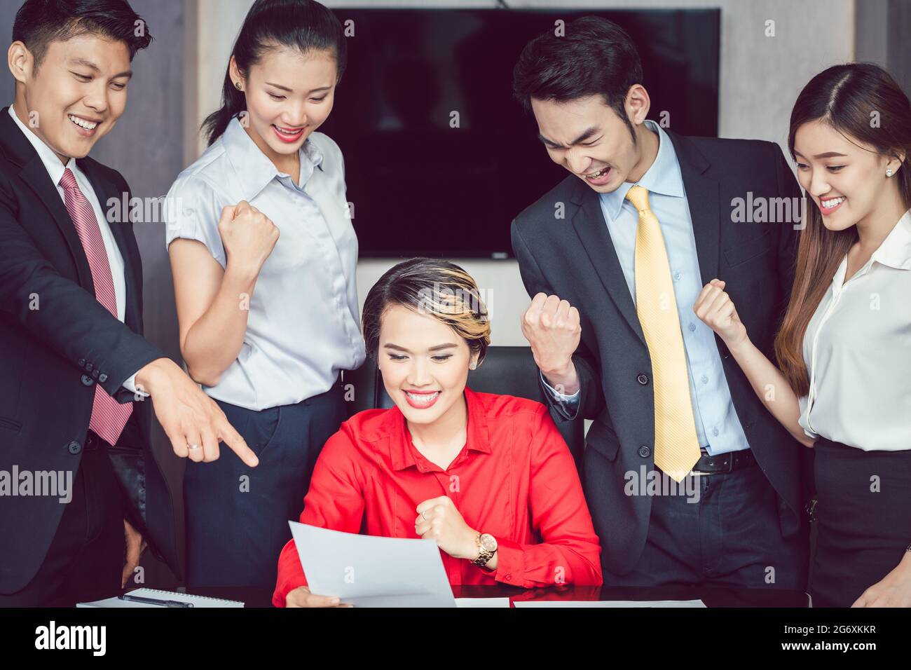 Ritratto di giovani imprenditori di successo stringendo il pugno guardando business report Foto Stock