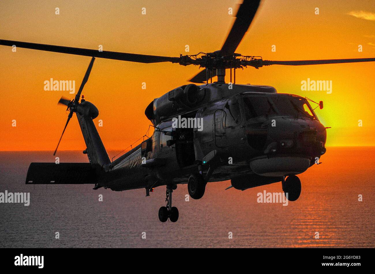 Un ritratto air-to-air di un elicottero Sikorsky S70B Seahawk della Marina australiana al tramonto Foto Stock