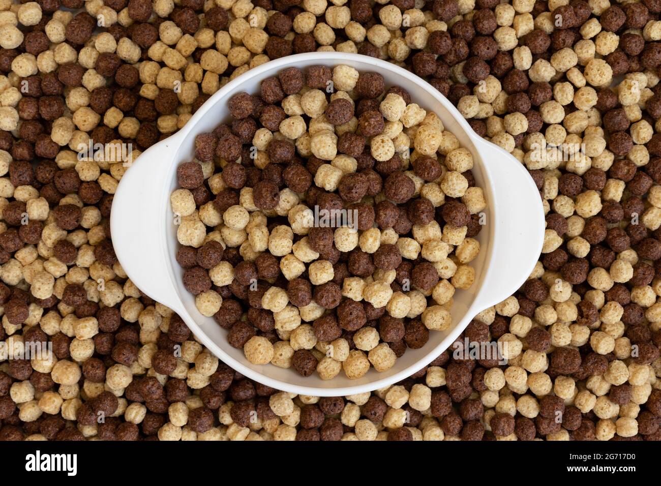 ciotola di cereali al cioccolato e alla vaniglia su sfondo cerealicolo, concetto di sana colazione Foto Stock