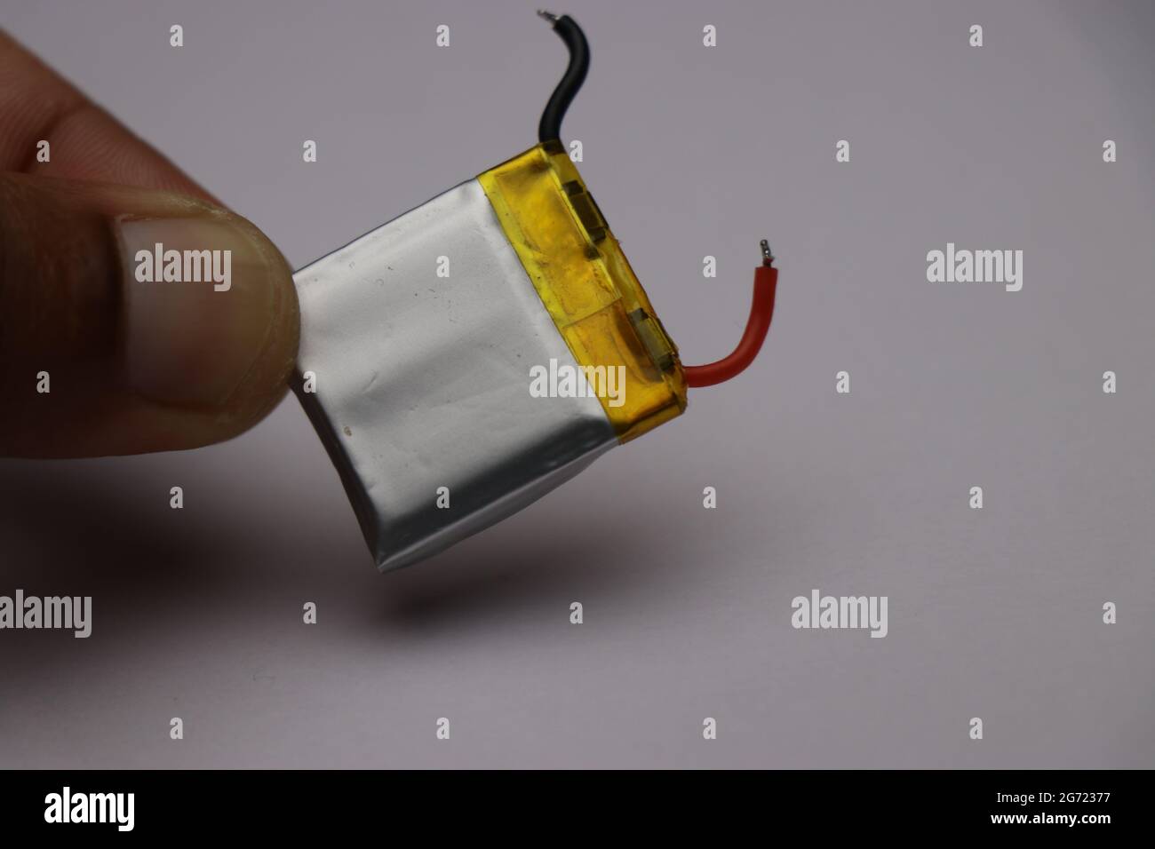 Batteria ai polimeri di litio che viene utilizzata per alimentare piccoli dispositivi elettronici chiamati anche batteria li-po in mano Foto Stock