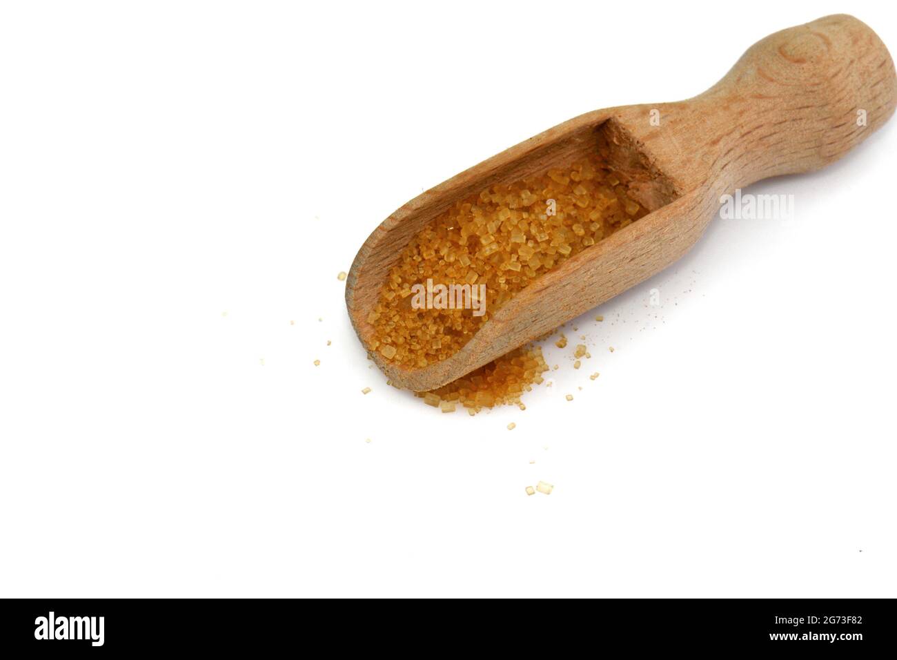 Zucchero di palma di cocco in un cucchiaio di legno isolato su bianco. Zucchero di palma di cocco marrone. Foto Stock