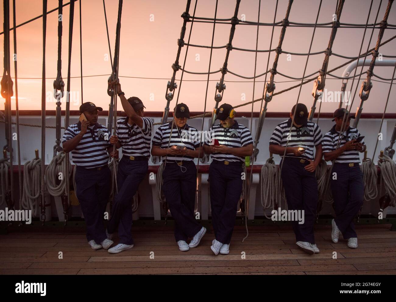 I marinai prendono adavantag di un breve momento di ricezione delle cellule per mettersi in contatto con casa. Buque Escuela Cuahutemoc, Armada Mexicana. Una nave messicana Marina a vela noi Foto Stock