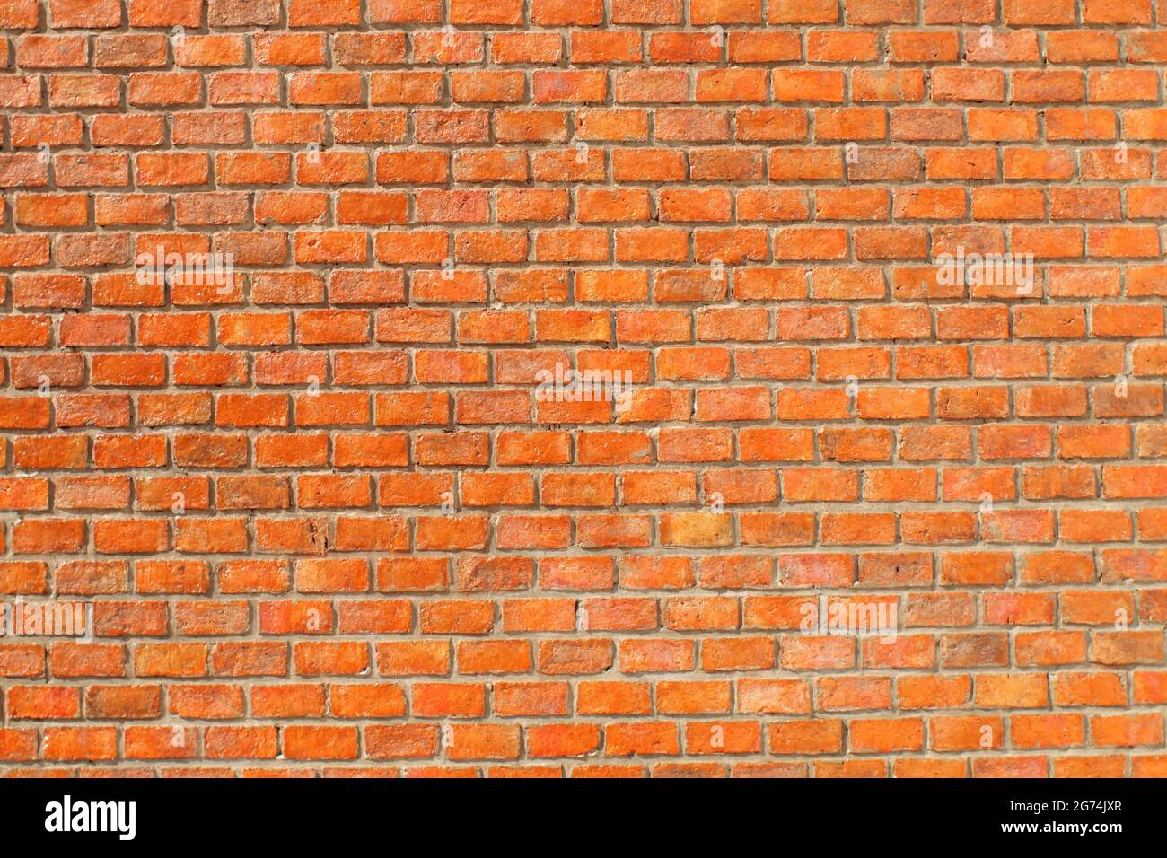 Materiale di architettura di sfondo arancione della parete in mattoni. Arancio mattone grunge muro sfondo modello di mappatura. Foto Stock