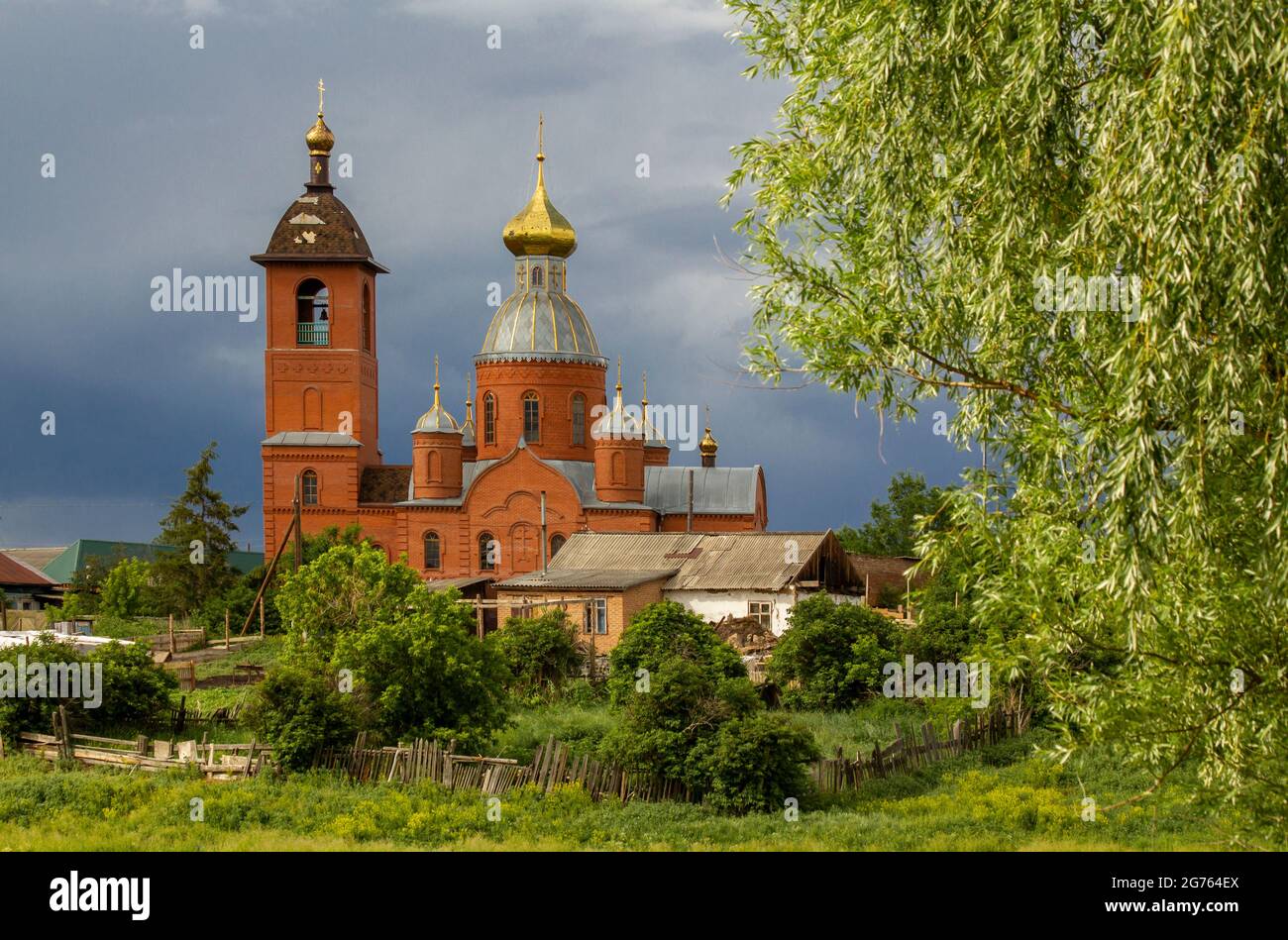 Vecchia chiesa rustica vicino alla foresta prima della pioggia. Foto Stock