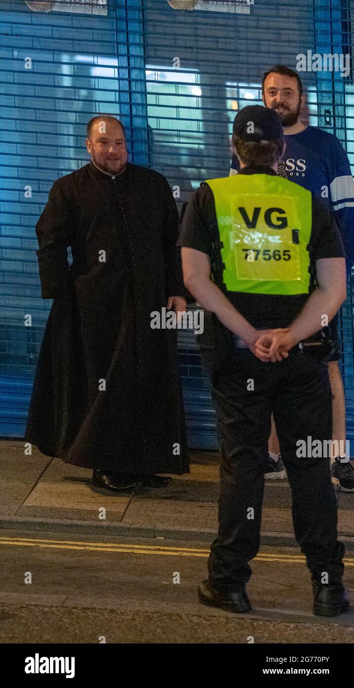 Brentwood Essex 11 luglio 2021 tifosi di calcio in inglese a Brentwood Essex UN sacerdote locale, Padre Matthew Austin, parla con un fan e la polizia Credit: Ian Davidson/Alamy Live News Foto Stock