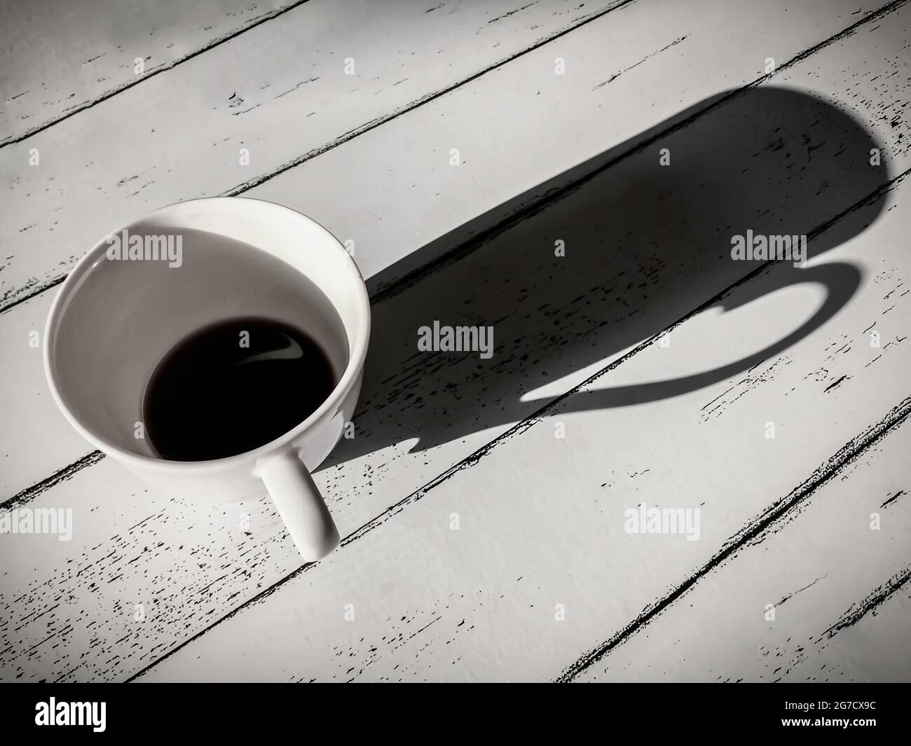Tazze da caffè su tavolo di legno bianco in stile vintage bianco e nero. Foto Stock