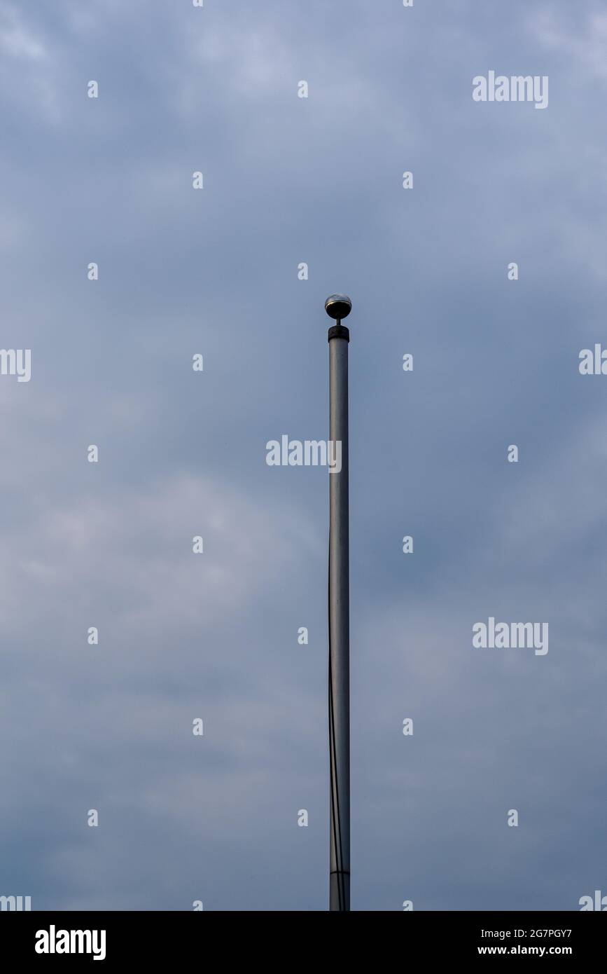 flagpole contro il cielo scuro Foto Stock