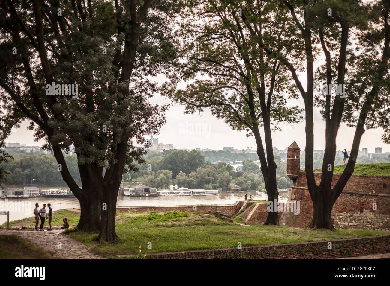 Foto del paesaggio di Nuova Belgrado, o Novi begrad, dal parco di Kalemegdan, al tramonto con la gente di fronte. Nuova Belgrado è un comune di t Foto Stock