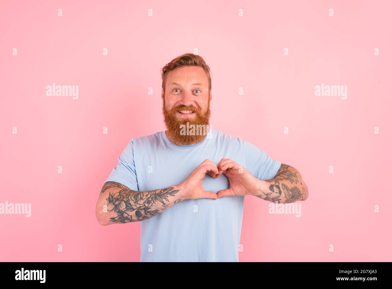 Uomo felice con barba e maglietta blu chiaro Foto Stock