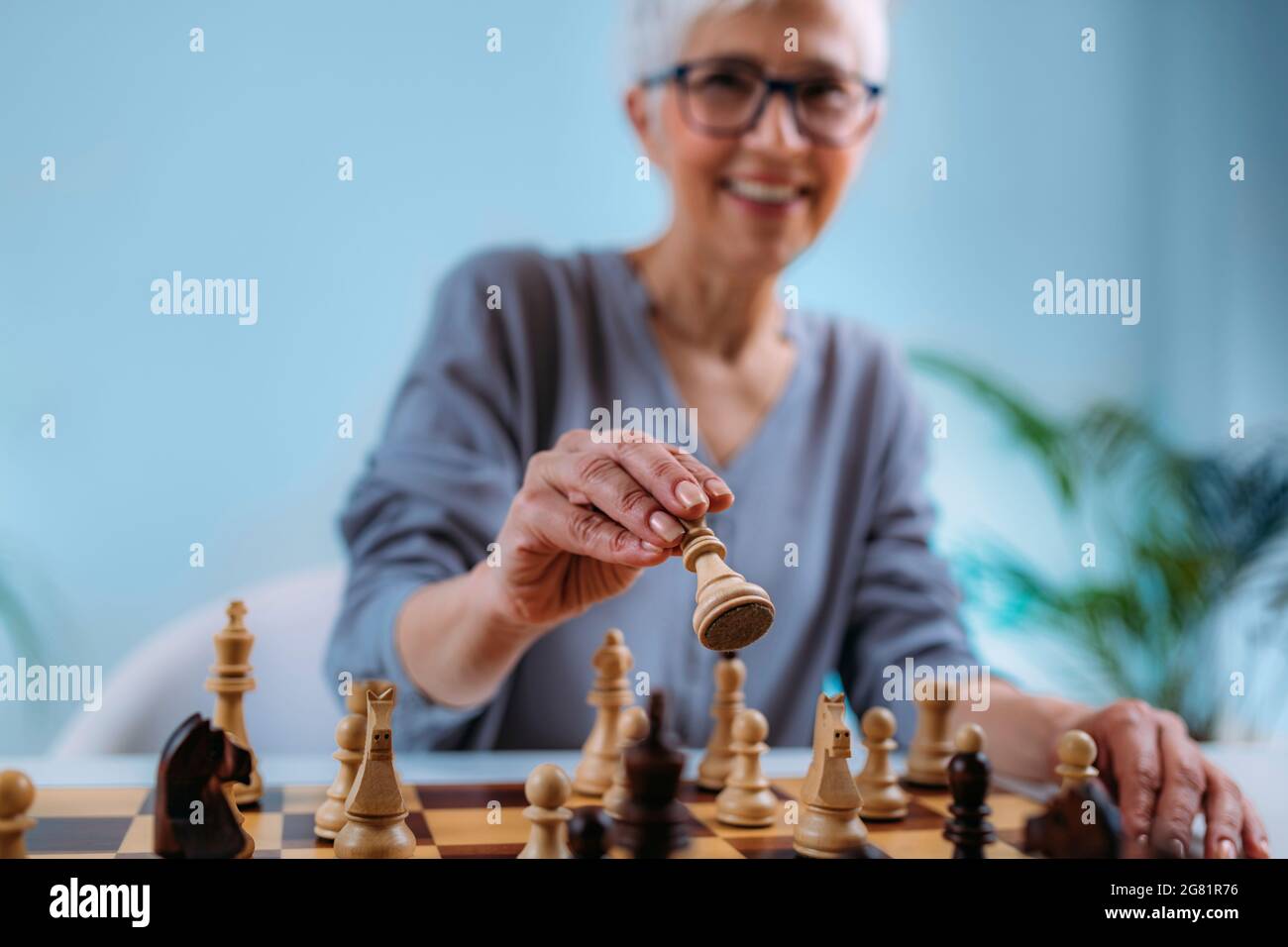 Senior donna giocando a scacchi Foto Stock
