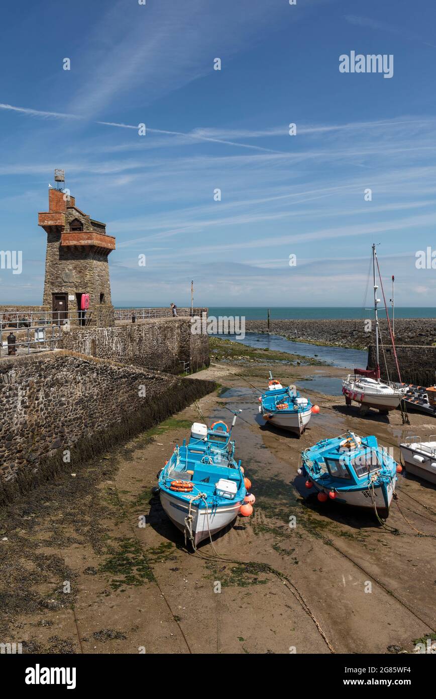 Marea fuori e le barche ormeggiate nel porto di Lynmouth con la storica Rhenish Tower sul molo. Exmoor National Park, Devon, Inghilterra, Regno Unito Foto Stock