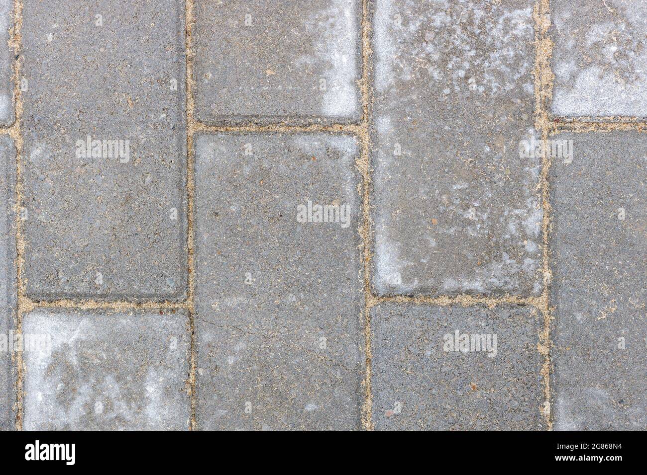 Struttura grigia di pietre da pavimentazione. Primo piano di piastrelle di pietra per marciapiedi. Vista dall'alto Foto Stock