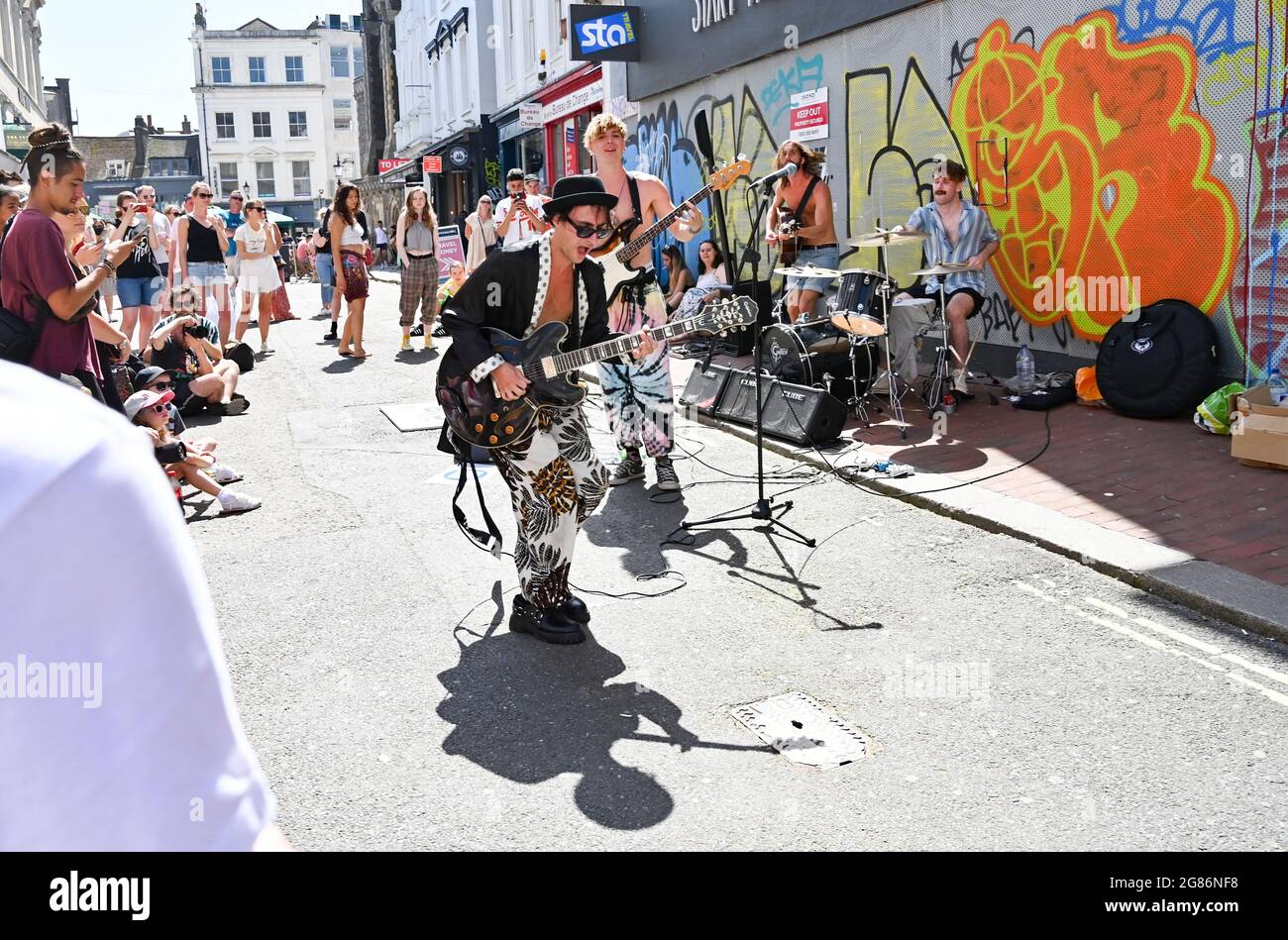 Brighton, Regno Unito. 17 luglio 2021 - UNA band si esibisce nel centro di Brighton, mentre migliaia di persone si affollano sul mare per godersi il caldo clima soleggiato . Un'onda di calore è prevista per il fine settimana in tutta la Gran Bretagna con temperature previste per raggiungere oltre 30 gradi centigradi in alcune aree: Credit Simon Dack / Alamy Live News Foto Stock