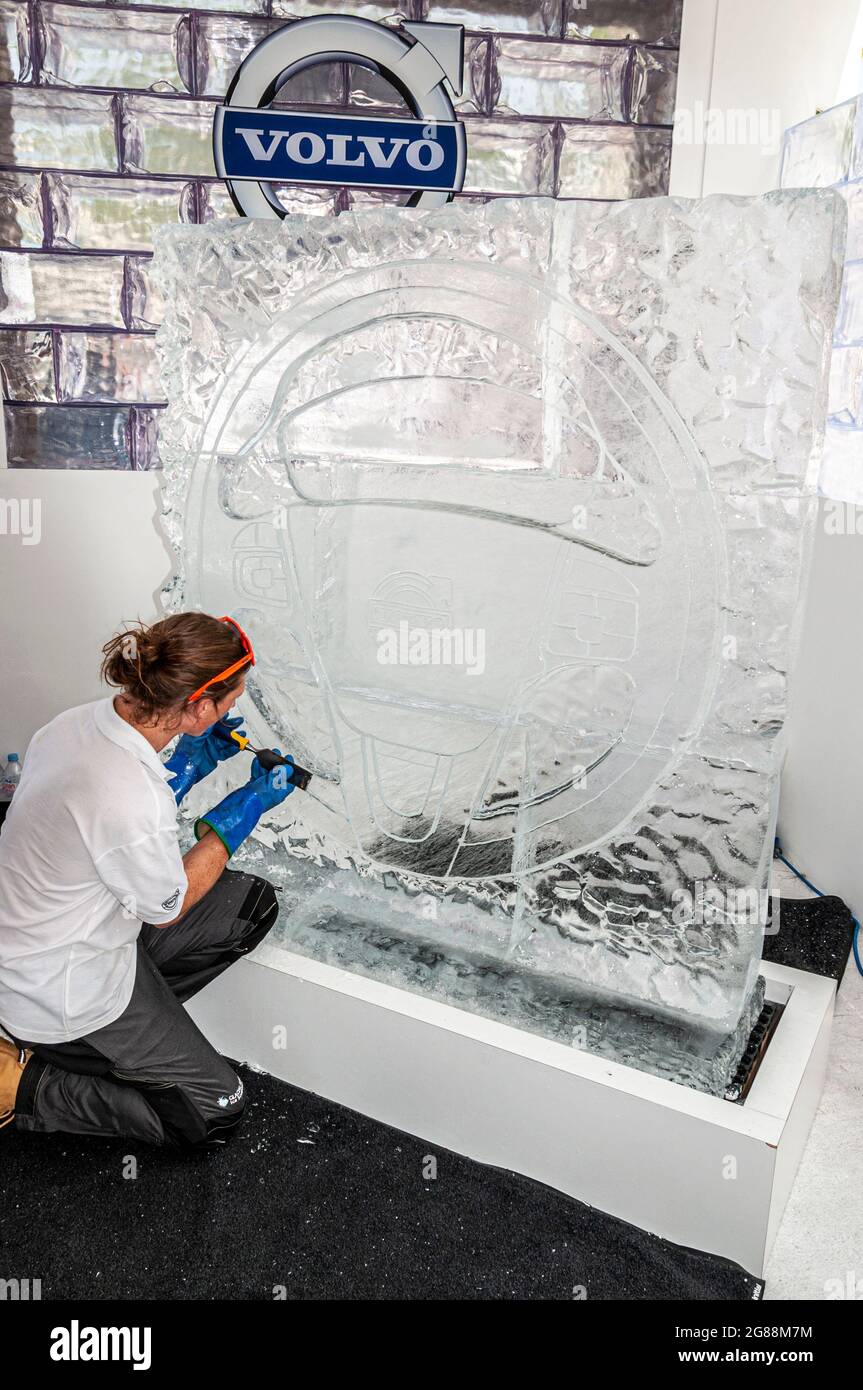 Persona che intaglia un marchio Volvo in una scultura su ghiaccio al Goodwood Festival of Speed 2013. Scalpellare il ghiaccio per modellare il pezzo d'arte promozionale Foto Stock