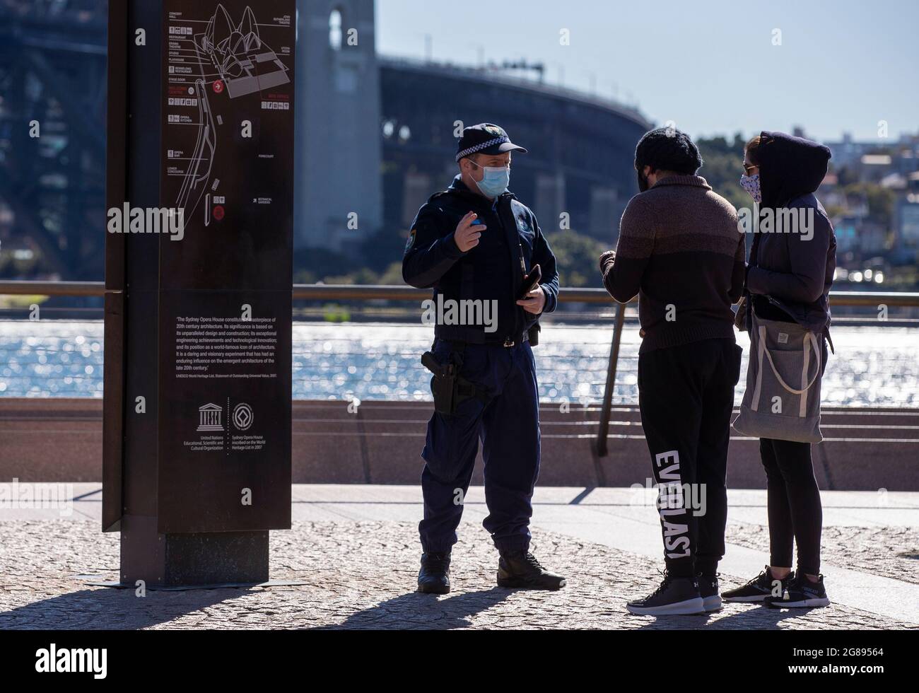 Sydney, Australia. 18 luglio 2021. La gente parla con un ufficiale di polizia a Sydney, Australia, 18 luglio 2021. L'aumento dei casi COVID-19 ha scatenato restrizioni più severe con un maggior numero di punti vendita chiusi nello stato australiano del nuovo Galles del Sud (NSW), epicentro dell'attuale epidemia del paese, sabato. Credit: Bai Xuefei/Xinhua/Alamy Live News Foto Stock