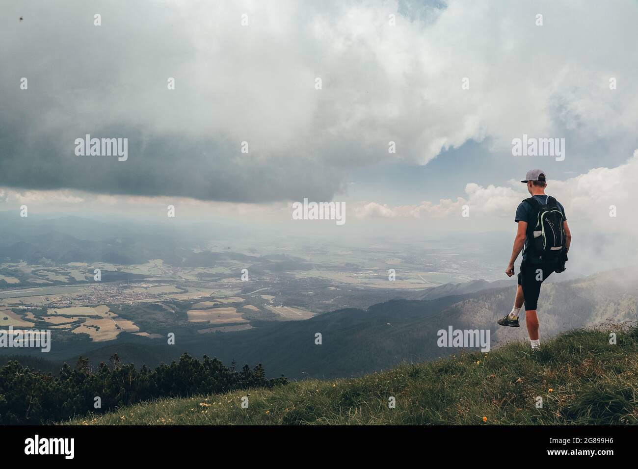 L'atleta biondo si pone sulla cima del monte Mala fatra. Arrampicata Monte Hromova. Un escursionista cammina lungo le creste di Lesser Fatra nelle montagne slovacche Foto Stock