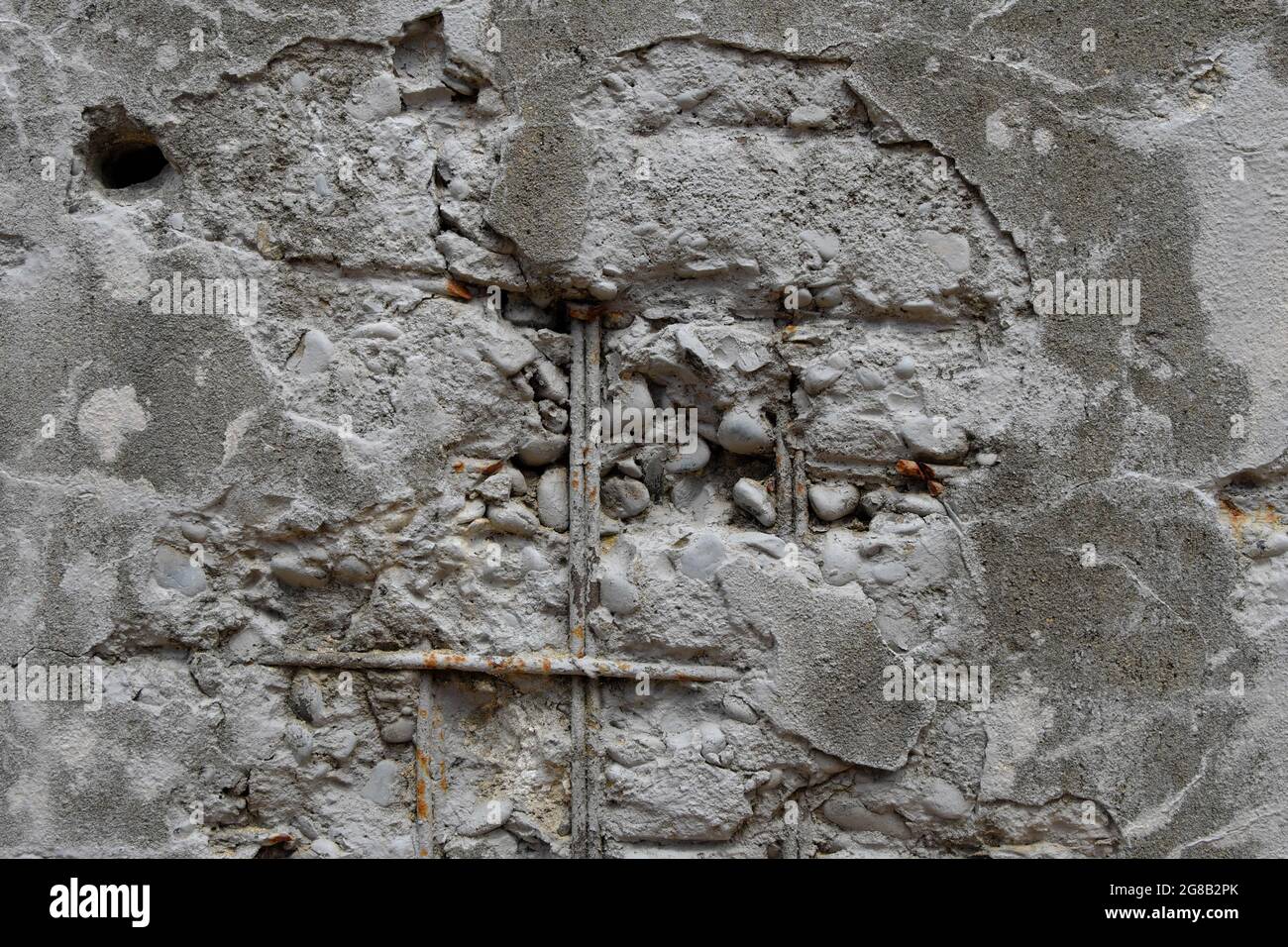 La struttura di una vecchia parete in cemento con una superficie incrinata e sbriciolata. Sfondo. Foto Stock