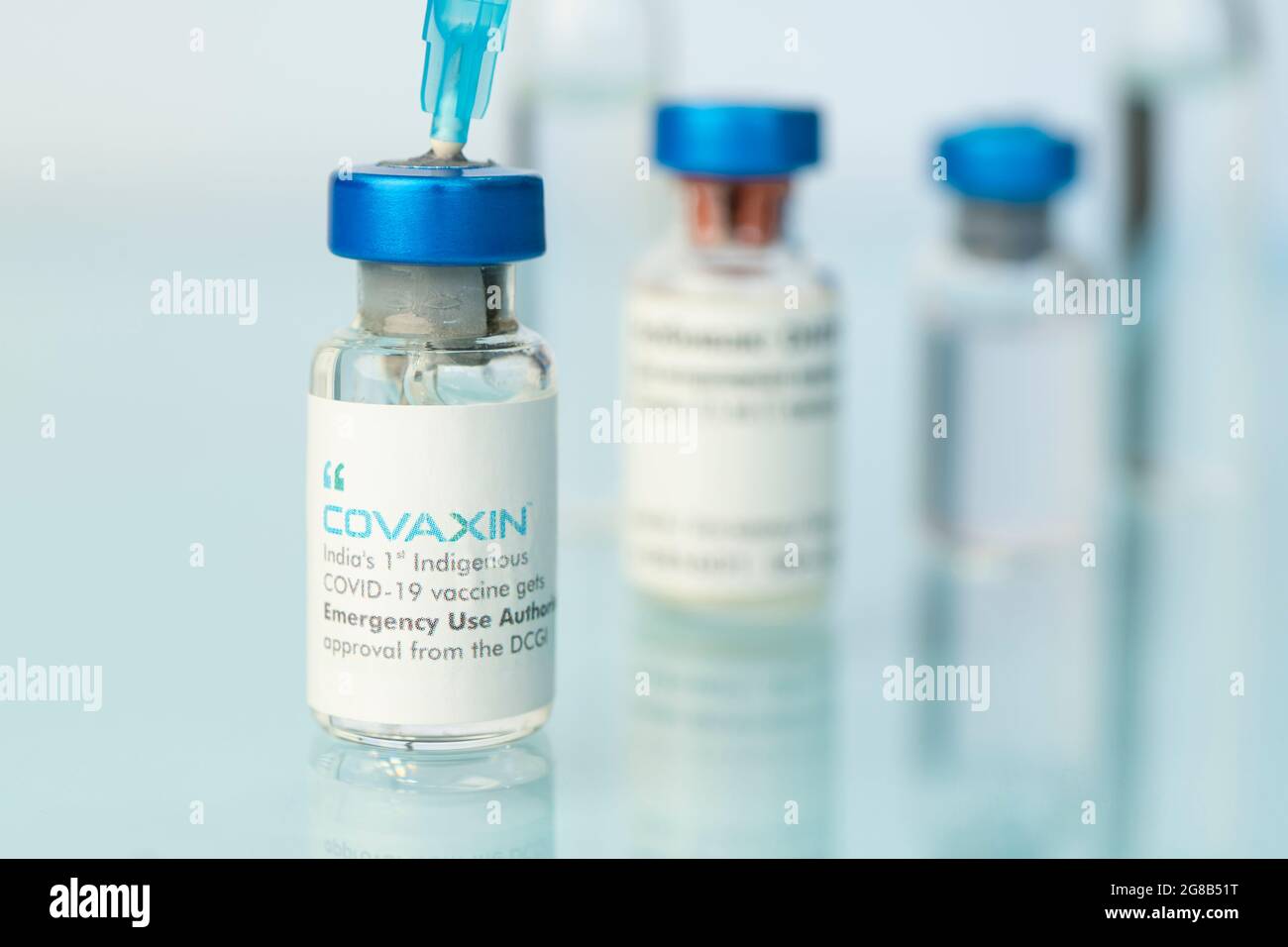 Una bottiglia di vaccino su un tavolo bianco su sfondo blu. 15 marzo 2021. Barnaul, Russia. Foto Stock