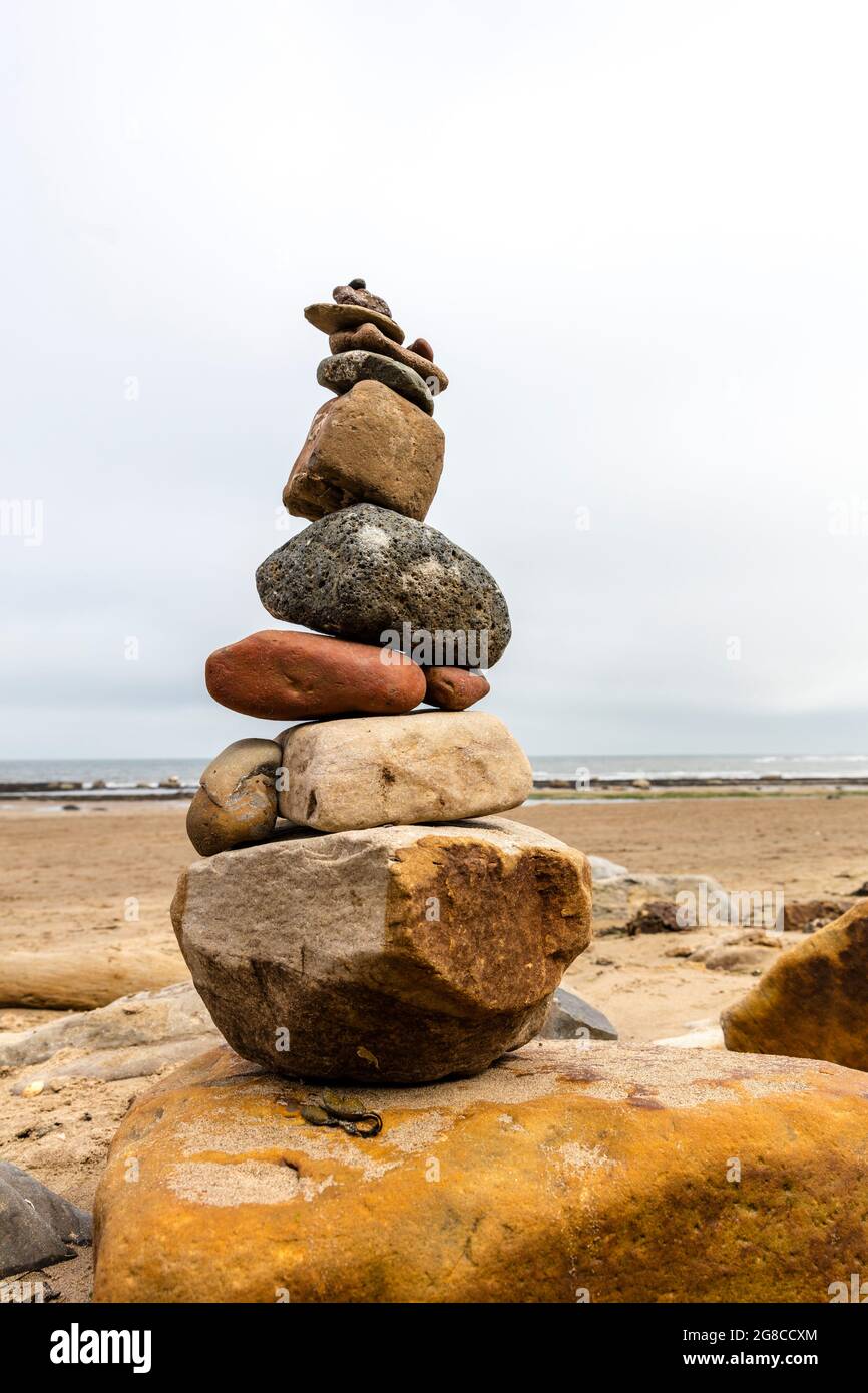 Balancing Act, Rock Cairn, Robin Hoods Bay, Yorkshire, Regno Unito, Inghilterra, bilanciamento del rock, rocce bilanciate, pietre bilanciate, cairn, cairns, metafora, vita, Foto Stock