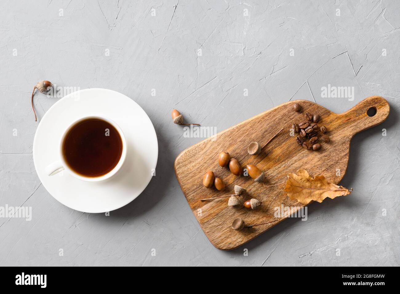 Caffè Acorn con foglie di quercia su sfondo grigio. Vista dall'alto. Spazio per il testo. Bevanda sana sostituto del caffè senza caffeina. Foto Stock