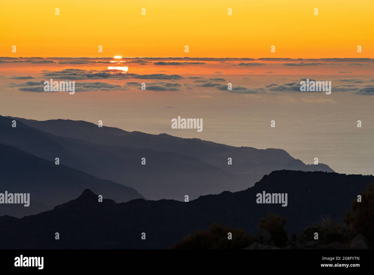 Cielo ardente al tramonto sull'Oceano Atlantico e silhouette di montagne dal picco di Pico Ruivo, Madeira, Portogallo, Atlantico, Europa Foto Stock