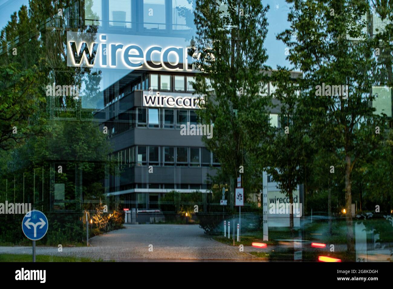 Mehrfachbelichtung der Wirecard Zentrale. Das Logo der Wirecard leuchtet. Blick auf die Zentrale des insolventen Dax Unternehmens Wirecard. Nachdem die Wirtschaftsprüfer Ernst & Young ( EY ) das Testat verweigert hatten und 1, 9 Milliarden Euro fehlen, konnte Wirecard die Angestellten nicht mehr bezahlen. Der ehemalige CEO Markus Braun saß zwischenzeitlich in Untersuchungshaft und der ehemalige COO Jan Marsalek ist untergetaucht und wird mit Haftbefehl gesucht. – Vista generale sulla sede del fallimento del fornitore globale di tecnologia Internet e di servizi finanziari Wirecard ad Aschheim nea Foto Stock