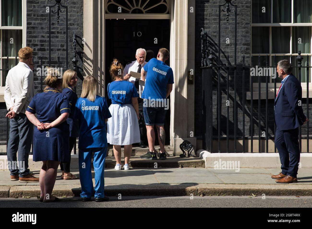 Londra, Regno Unito. 20 luglio 2021. L'infermiera del Galles del NHS Matthew Tovey presenta la sua petizione NHSPay15 firmata da oltre 800,000 persone che chiedono un aumento salariale del 15% per i lavoratori del NHS a 10 Downing Street, accompagnati dai deputati Jeremy Corbyn, Lloyd Russell-Moyle e Ian Byrne e da altri attivisti. Al momento della presentazione della petizione, si credeva che il governo si preparasse ad offrire ai lavoratori della NHS un aumento retributivo del 3% nella "conoscenza dell'impatto unico della pandemia sull'NHS". Credit: Mark Kerrison/Alamy Live News Foto Stock