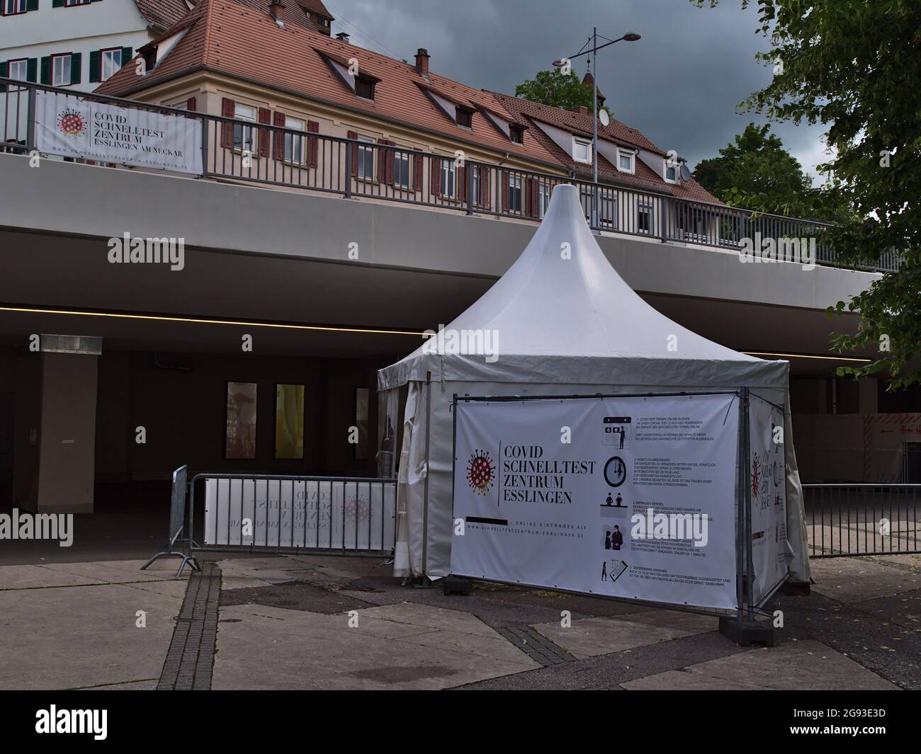 Tenda bianca del centro di test Covid-19 nel centro di Esslingen, che offre test del coronavirus ai cittadini durante la pandemia, con istruzioni su poster. Foto Stock
