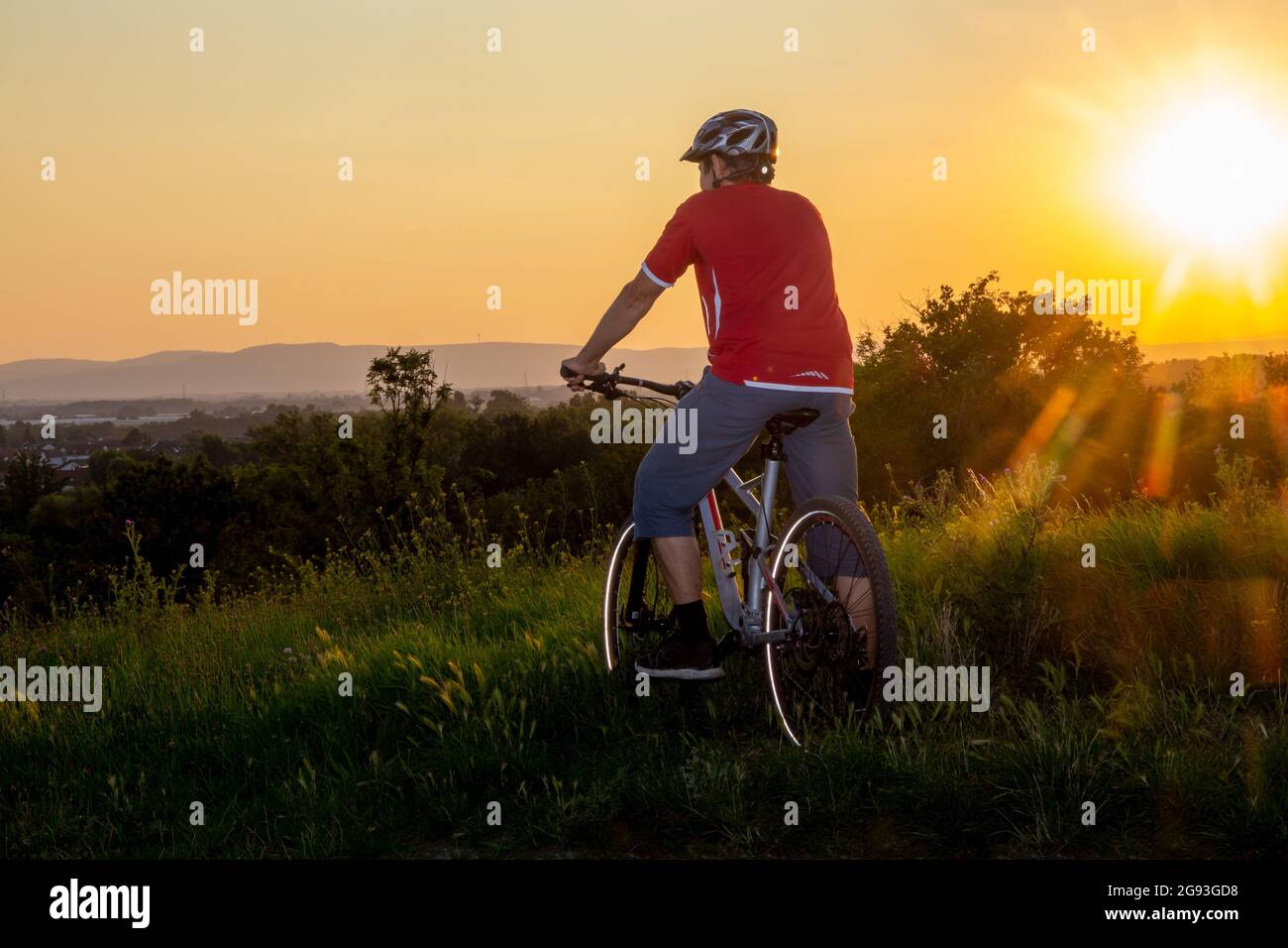 Immagine simbolica: Mountain bike godendo la vista al tramonto (modello rilasciato) Foto Stock