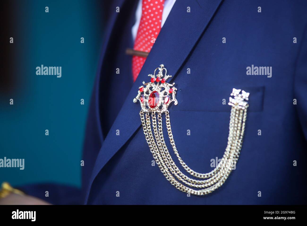 Primo piano di una spilla di abbigliamento su un tuxedo blu con una  cravatta a pois rossa Foto stock - Alamy