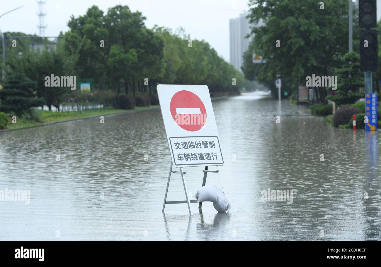 Ningbo, provincia cinese di Zhejiang. 26 luglio 2021. Un segnale di deviazione è posto su una strada loggata e un controllo temporaneo del traffico è in funzione nella città di Yuyao di Ningbo, la provincia di Zhejiang della Cina orientale, 26 luglio 2021. Il tifone in-fa fece la seconda caduta nella provincia di Zhejiang intorno alle 9:50 di lunedì, causando l'aumento del livello dell'acqua della rete fluviale di Ningbo. Credit: Weng Xinyang/Xinhua/Alamy Live News Foto Stock