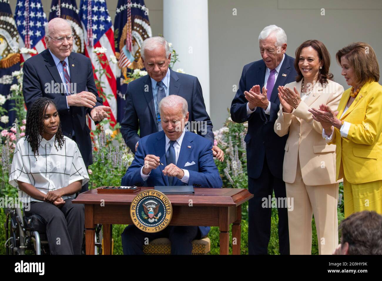 Da sinistra, l'artista Tiree Brown, il senatore Patrick Leahy (D-VT), l'ex congressista Tony Coelho, il presidente degli Stati Uniti Joe Biden, la Rep. Steny Hoyer (D-MD), il vicepresidente Kamala Harris e il presidente della Rep. Nancy Pelosi (D-CA), Riunirsi dopo che il presidente Biden ha firmato un'espansione degli Americani con disabilità Act per includere le condizioni relative a lungo COVID, nel Giardino delle Rose della Casa Bianca a Washington, il Lunedi, 26 luglio 2021. Credit: Amanda Andrade-Rhoades/CNP Foto Stock