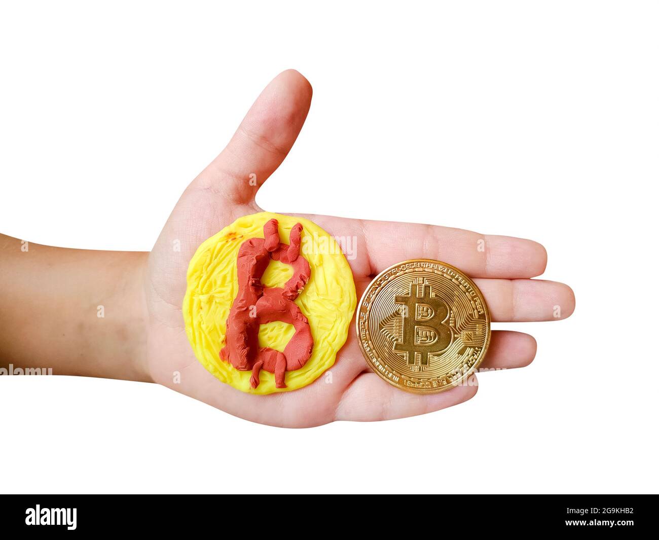 Plastilina e vera moneta gettone Bitcoin nella mano del bambino isolato su sfondo bianco Foto Stock