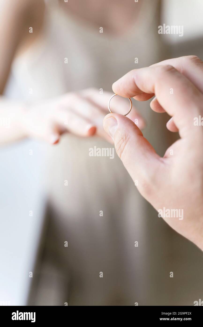 lo sposo mette l'anello sul primo piano del dito della sposa. matrimonio Foto Stock
