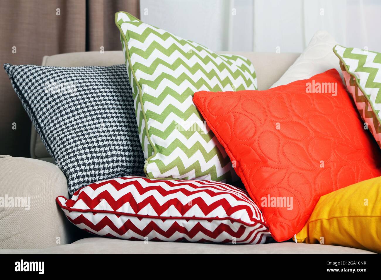 Divano con cuscini colorati in camera Foto stock - Alamy