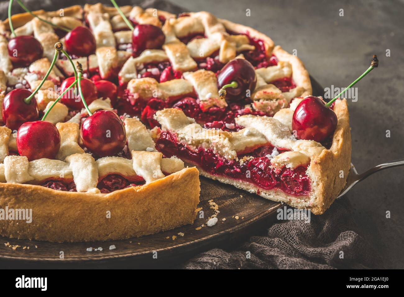 Primo piano di torta di ciliegie fatta in casa con un pezzo di sticking out Foto Stock