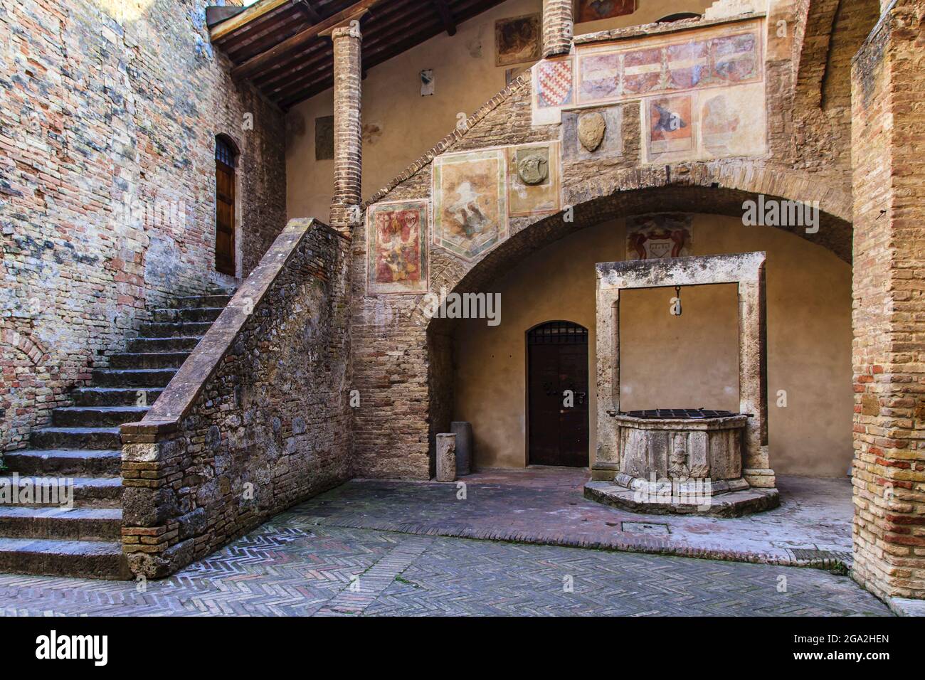 Pozzo d'acqua medievale nel cortile di Palazzo del Popolo; San Gimignano, Provincia di Siena, Toscana, Italia Foto Stock
