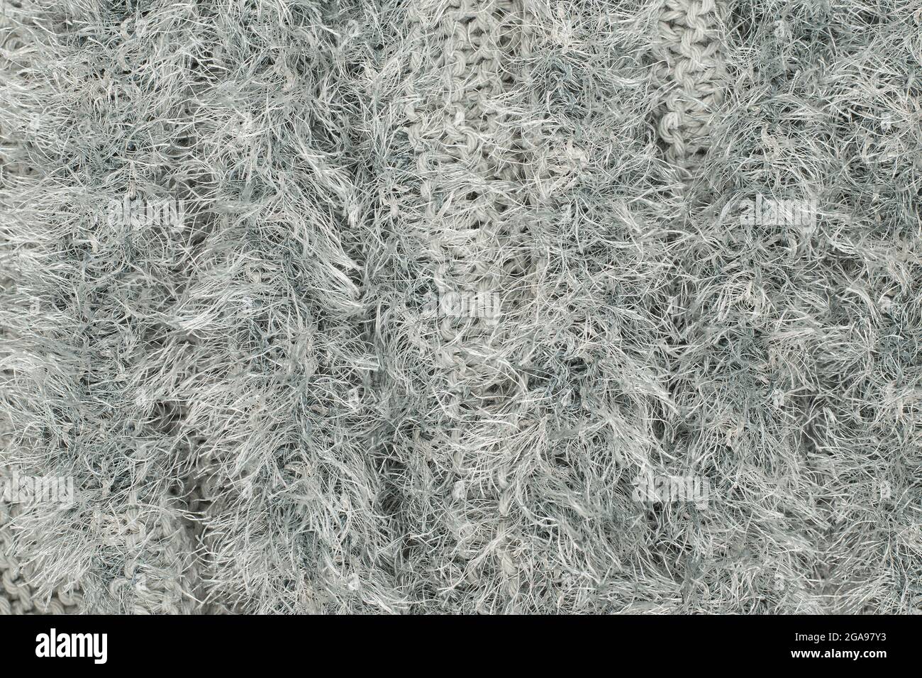 Struttura di un tappeto di shag fatto di materiali sintetici, fili bianchi. Foto Stock