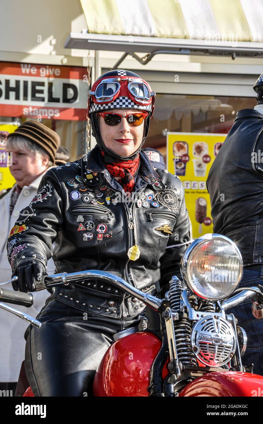Motociclista femminile in pelle nera retrò all'evento Goodwood Revival. Vintage, classico, senza tempo. Fai un passo indietro nella nostalgia del tempo Foto Stock