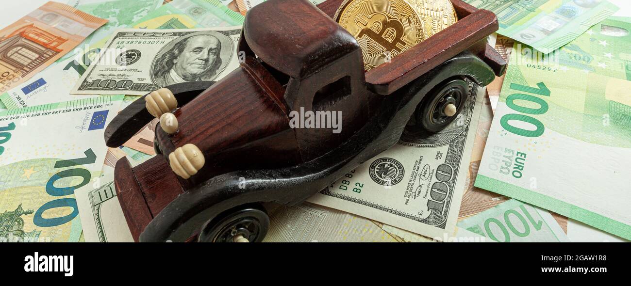 macchina in legno con bitcoin su euro e dollari texture sfondo panorama Foto Stock