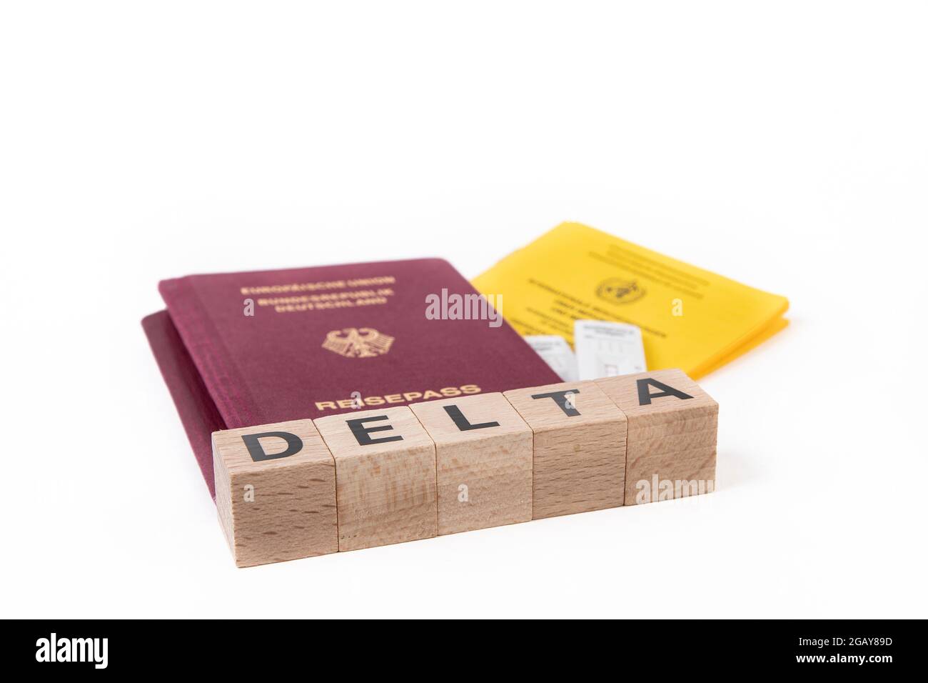 Huerth, NRW, Germania, 08 01 2021, passaporto tedesco e libro di vaccini, blocco di legno con la parola DELTA Foto Stock