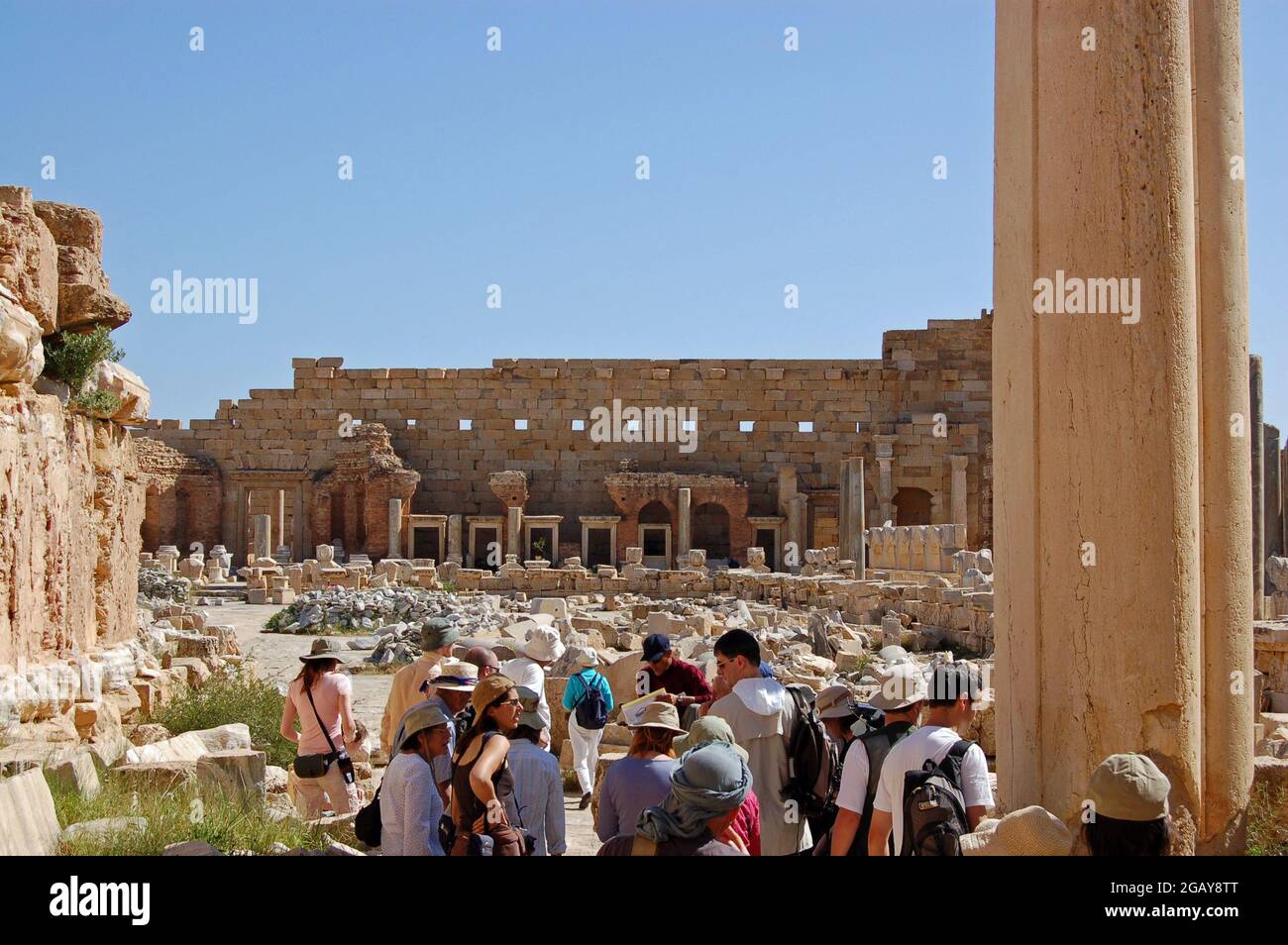 Leptis Magna, Libia - 2 aprile 2006: Turisti all'ingresso delle rovine del Foro Severo nell'antica città romana di Leptis Magna, a nord Foto Stock