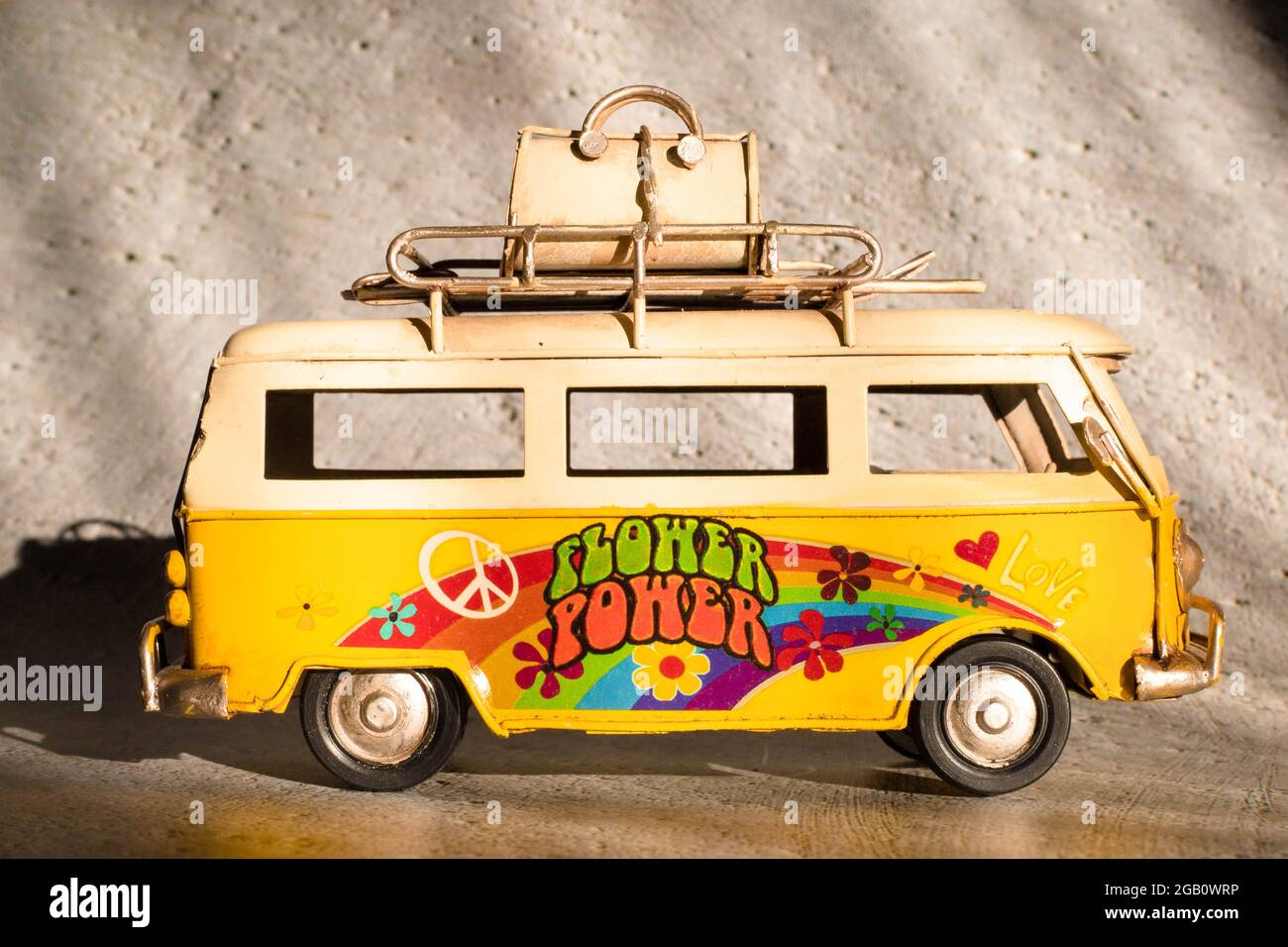 Piccolo giocattolo giallo furgone hippie. Concetto di vacanza, viaggio Foto Stock