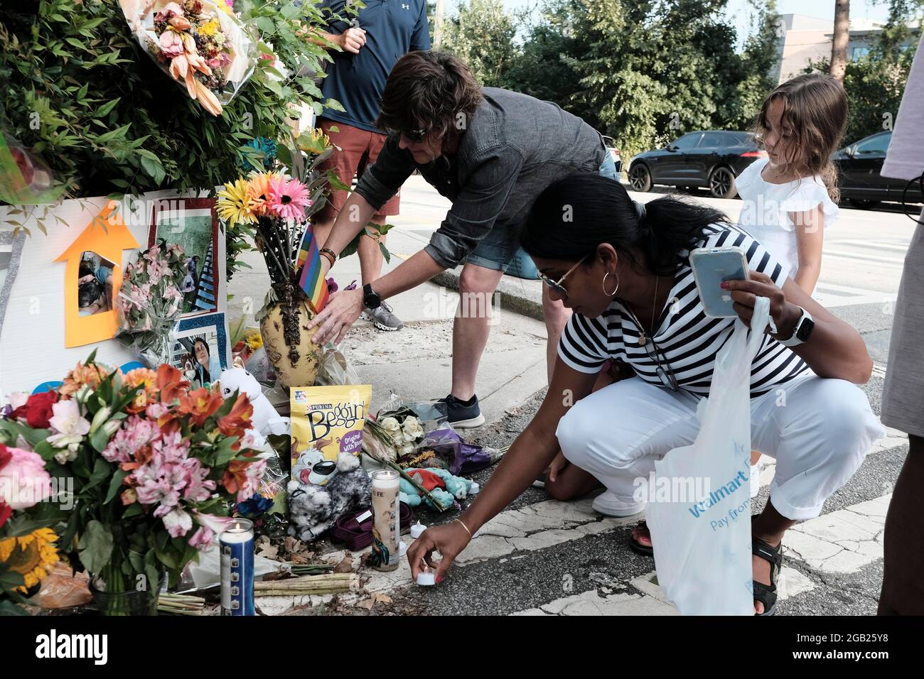 Atlanta, Georgia, Stati Uniti. 1 agosto 2021. Membri del Midtown Place di Atlanta candele e fiori in un memoriale di fortuna al Piedmont Park per LGBTQ Atlantan Katherine Janness e il suo cane, Bowie; entrambi sono stati trovati morti al Piedmont Park all'inizio di mercoledì intorno alle 1:00. Janness è stato trovato con ferite di stab multiple. E' in corso un'indagine, in quanto non sono stati individuati sospetti e non sono stati effettuati arresti in questo momento. (Immagine di credito: © John Arthur Brown/ZUMA Press Wire) Foto Stock