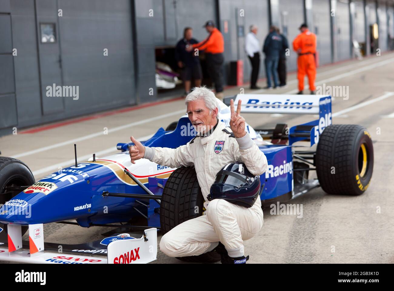 Damon Hill in posa accanto al suo Campionato del mondo vincendo la Williams FW18 Formula One Car, dopo aver eseguito diversi giri dimostrativi ad alta velocità del circuito, al Silverstone Classic 2021 Foto Stock